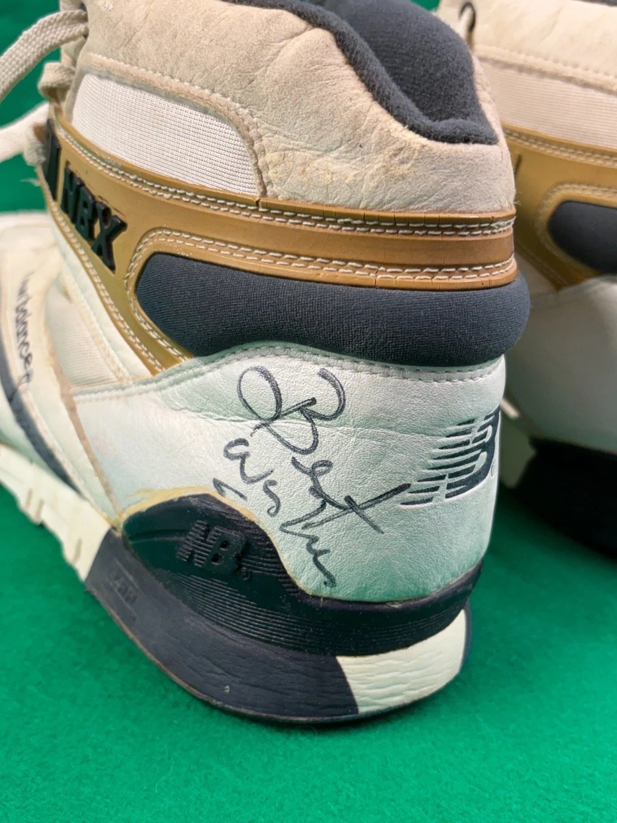 Back of both shoes with signatures on the heels