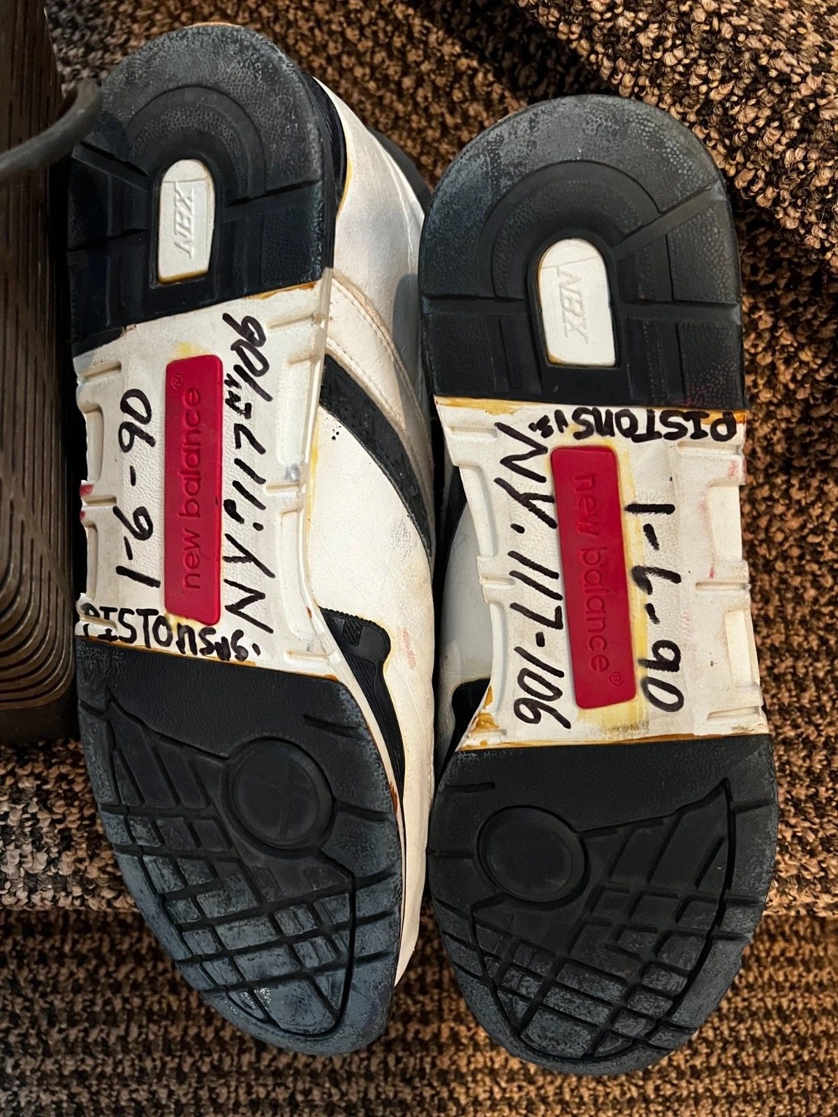 Soles of the shoes on a carpet, marked 1-6-90