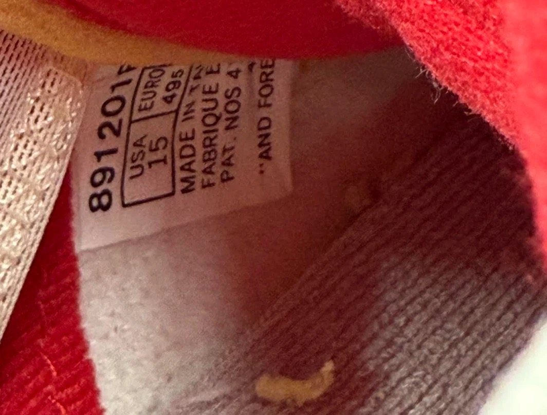 Inside tag of the sneaker reading USA size 15