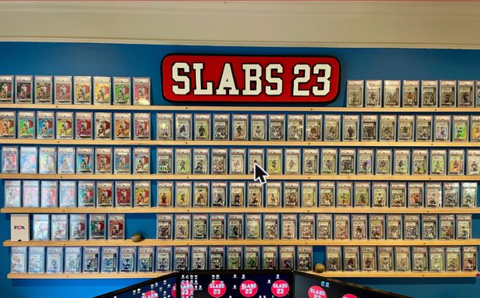 The full wall of PSA-graded slabs beneath the Slabs 23 sign