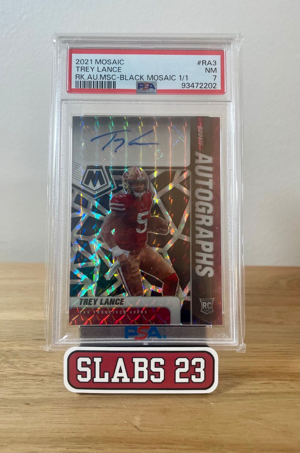 Trey Lance 2021 Mosaic rookie autograph, Black Mosaic 1/1 parallel, PSA 7 NM, on a Slabs 23 stand